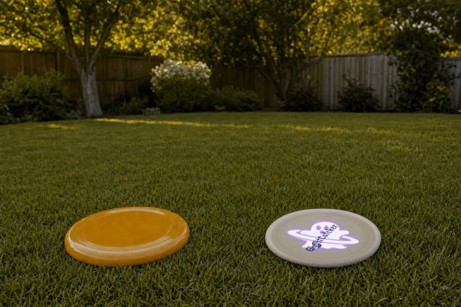 Dog view: the orange disc sinks into the grass colour while GHOSTCATCHER shows its glowing UV ghost pattern